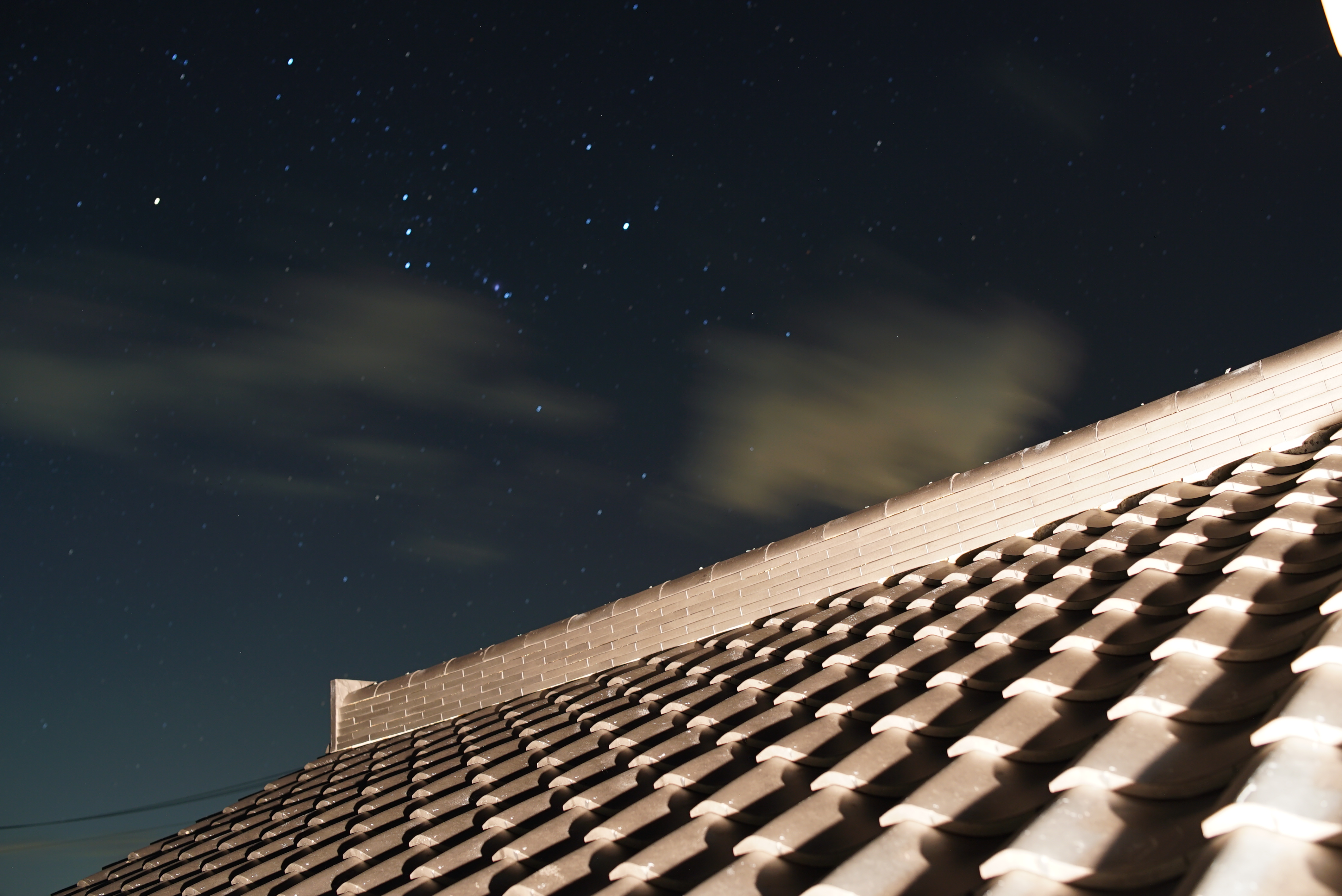 瓦屋根とオリオン座。屋根の上に積んであるのがのし瓦、手前のS字型が桟瓦。 photo by 上田謙太郎